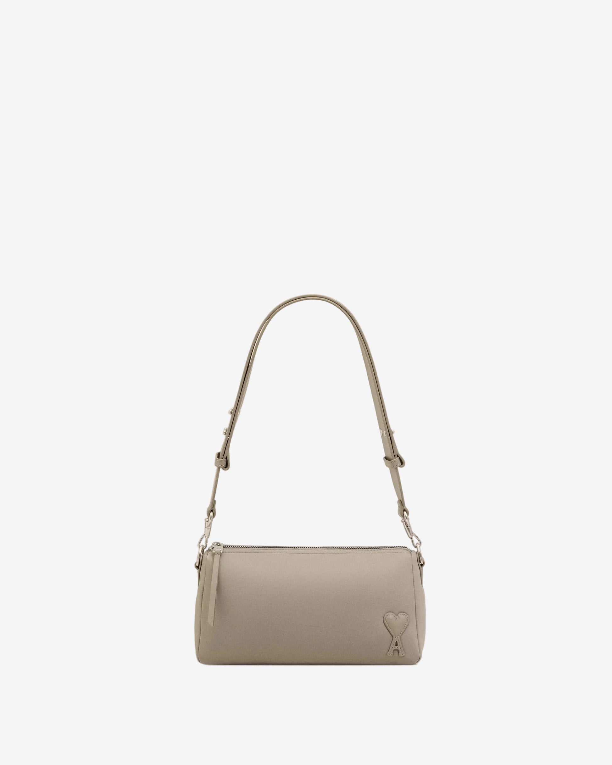 Light gray handbag with a heart detail on a light beige background ami paris
