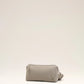 Light gray handbag with a heart detail on a light beige background ami paris