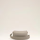 Light gray handbag with a heart detail on a light beige background ami paris