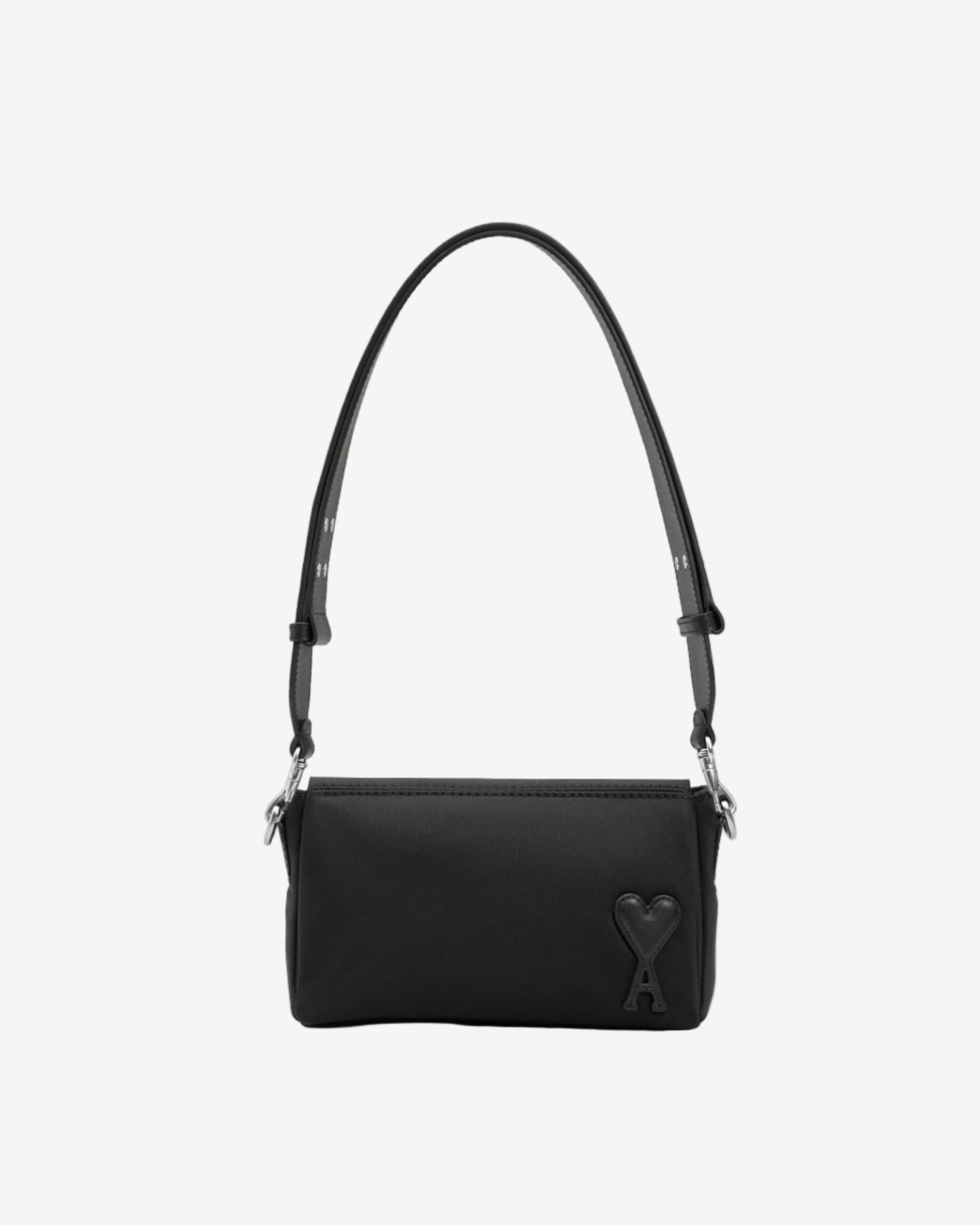 Black handbag with a strap on a light beige background