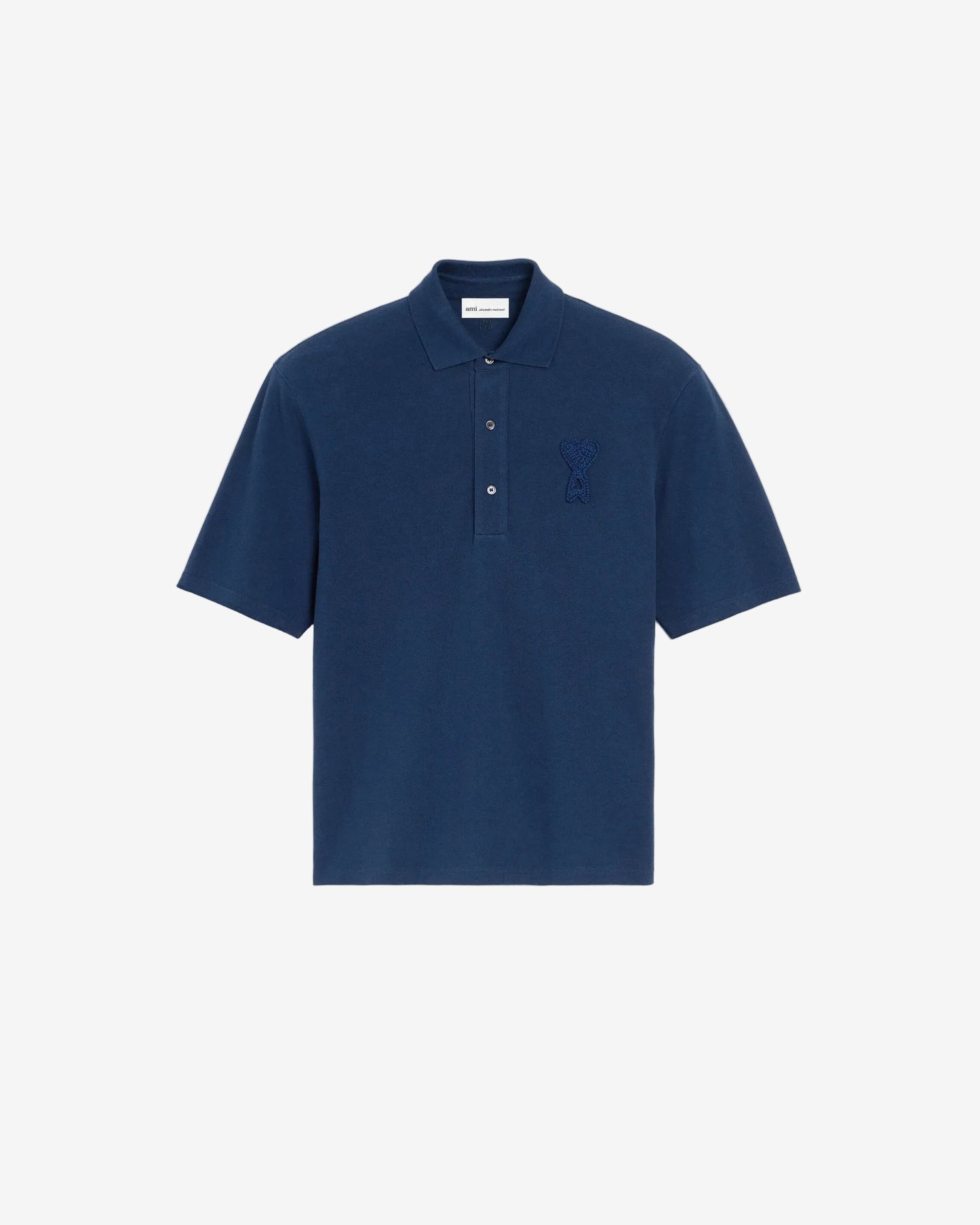 Navy blue polo shirt with a small logo on a beige background ami paris