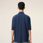 Navy blue polo shirt with a small logo on a beige background ami paris