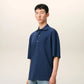 Navy blue polo shirt with a small logo on a beige background ami paris