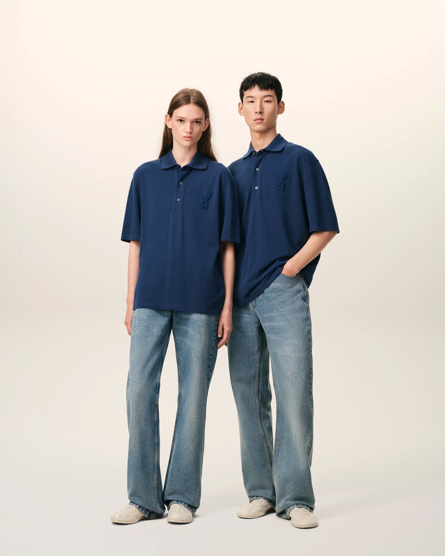 Navy blue polo shirt with a small logo on a beige background ami paris