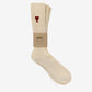 Beige sock with a red heart logo on a white background