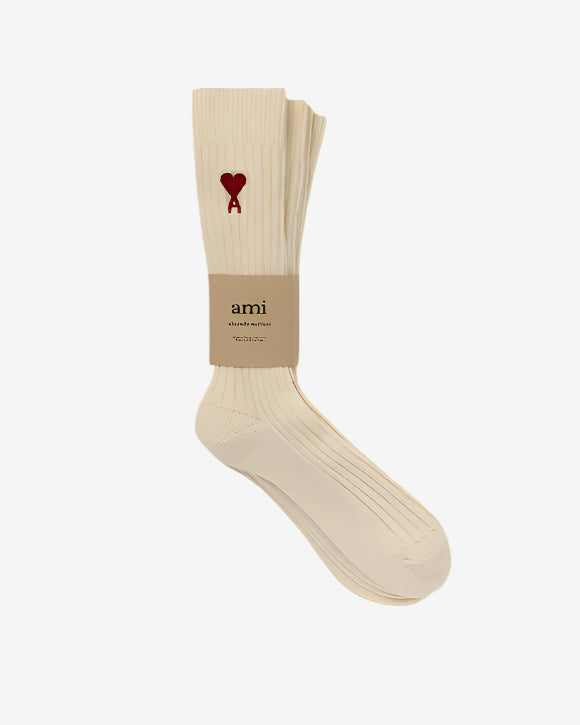 Beige sock with a red heart logo on a white background