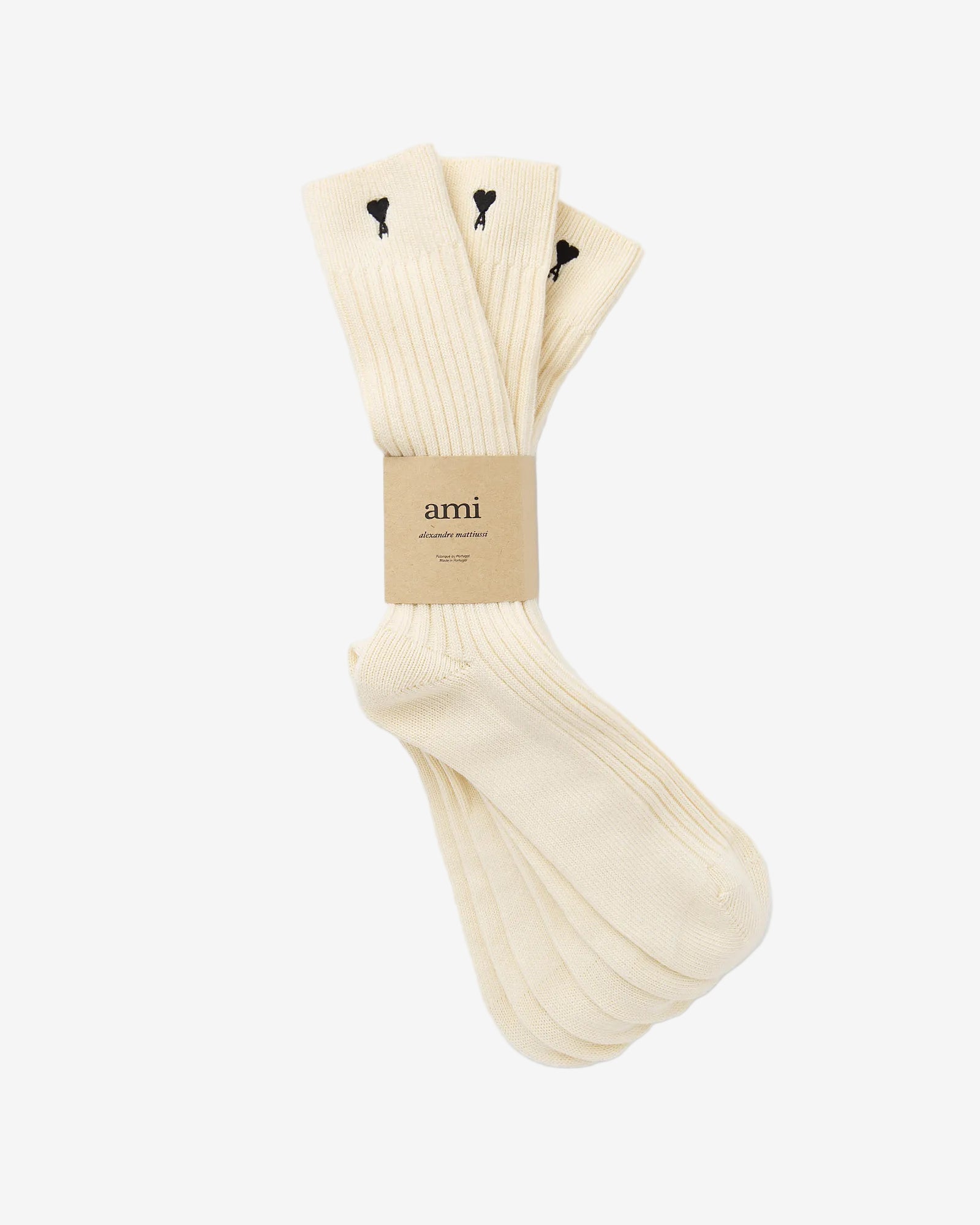 Pair of cream socks with a visible brand label on a light gray background