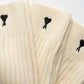 Pair of cream socks with a visible brand label on a light gray background