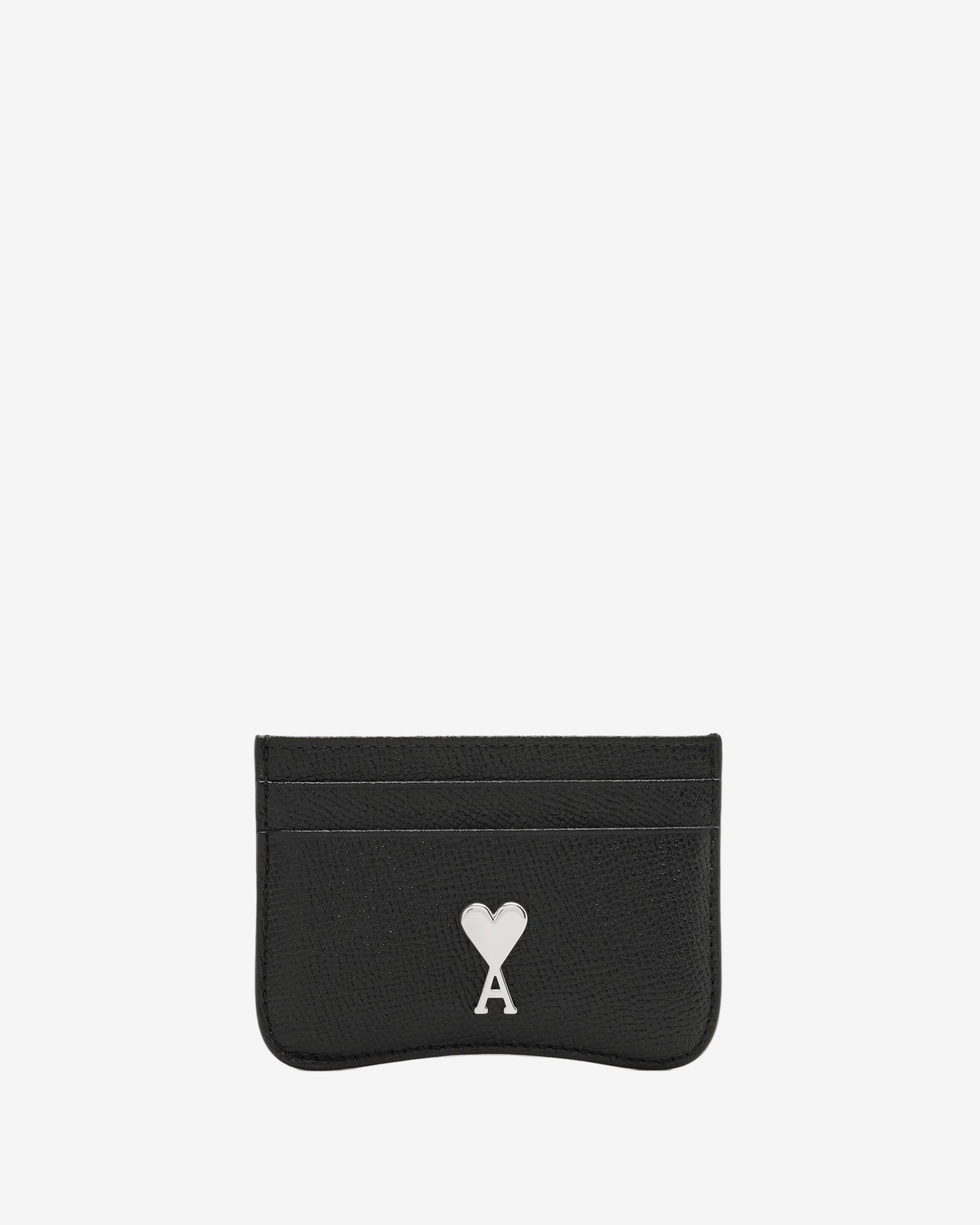 Black cardholder with a white logo on a beige background