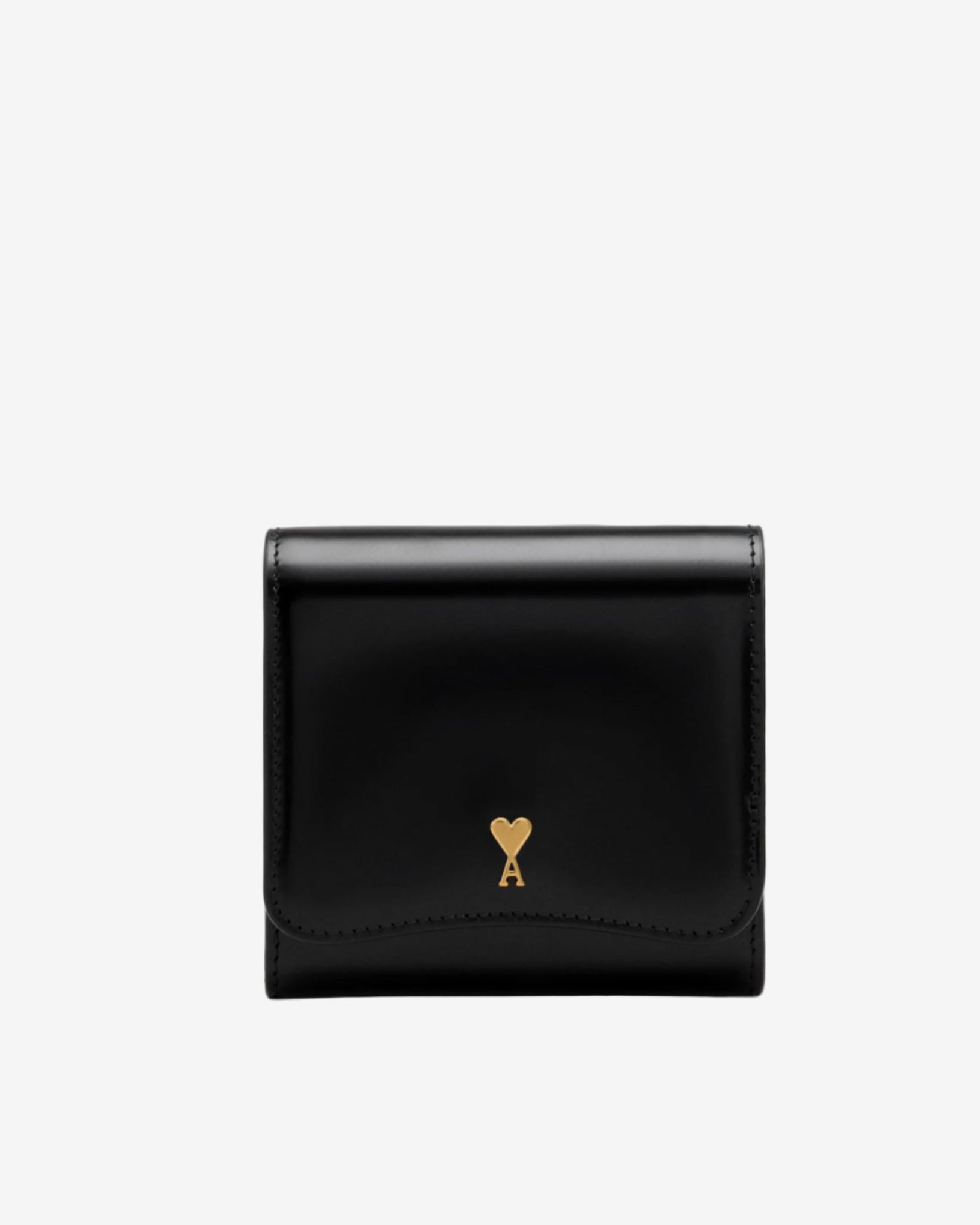 Black wallet with a heart-shaped logo on a beige background