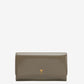 Green wallet with a small logo on a beige background