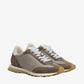 Pair of brown sneakers with white laces on a beige background
