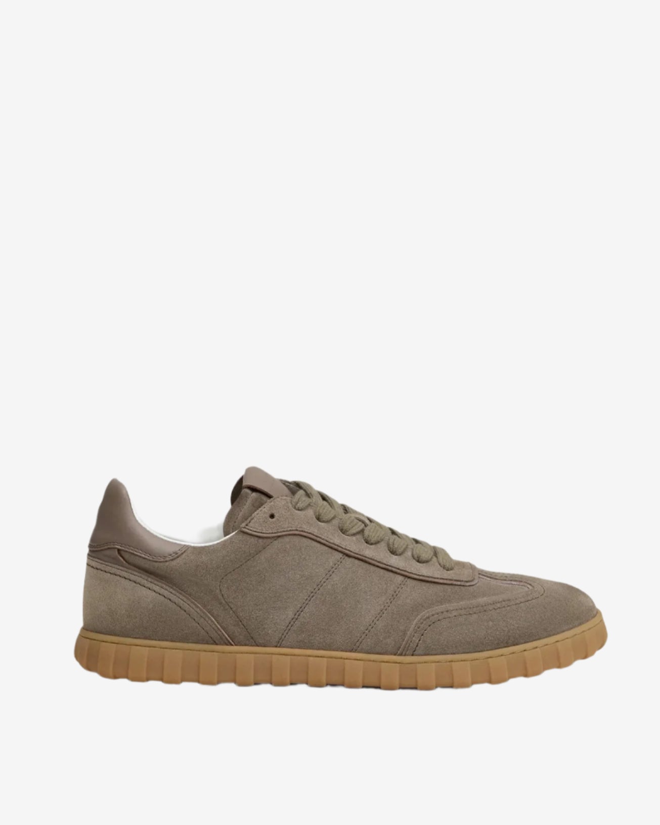 Beige sneaker with brown sole on a light beige background