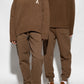 Brown sweatpants with a drawstring on a white background