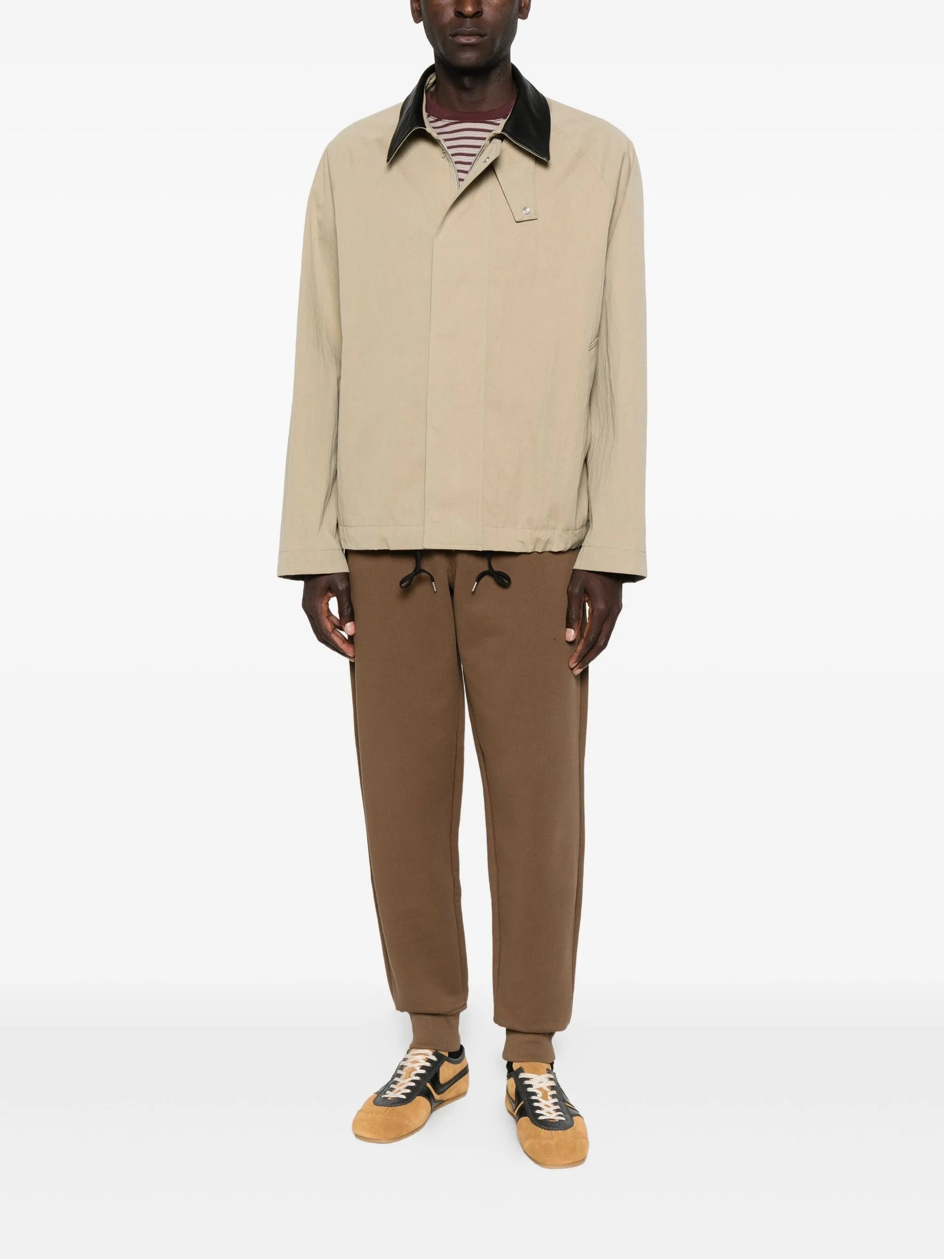 Brown sweatpants with a drawstring on a white background