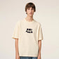 Beige t-shirt with 'AM! PARIS' text on a light gray background