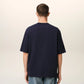 Navy blue t-shirt with 'AMI PARIS' text on a light gray background