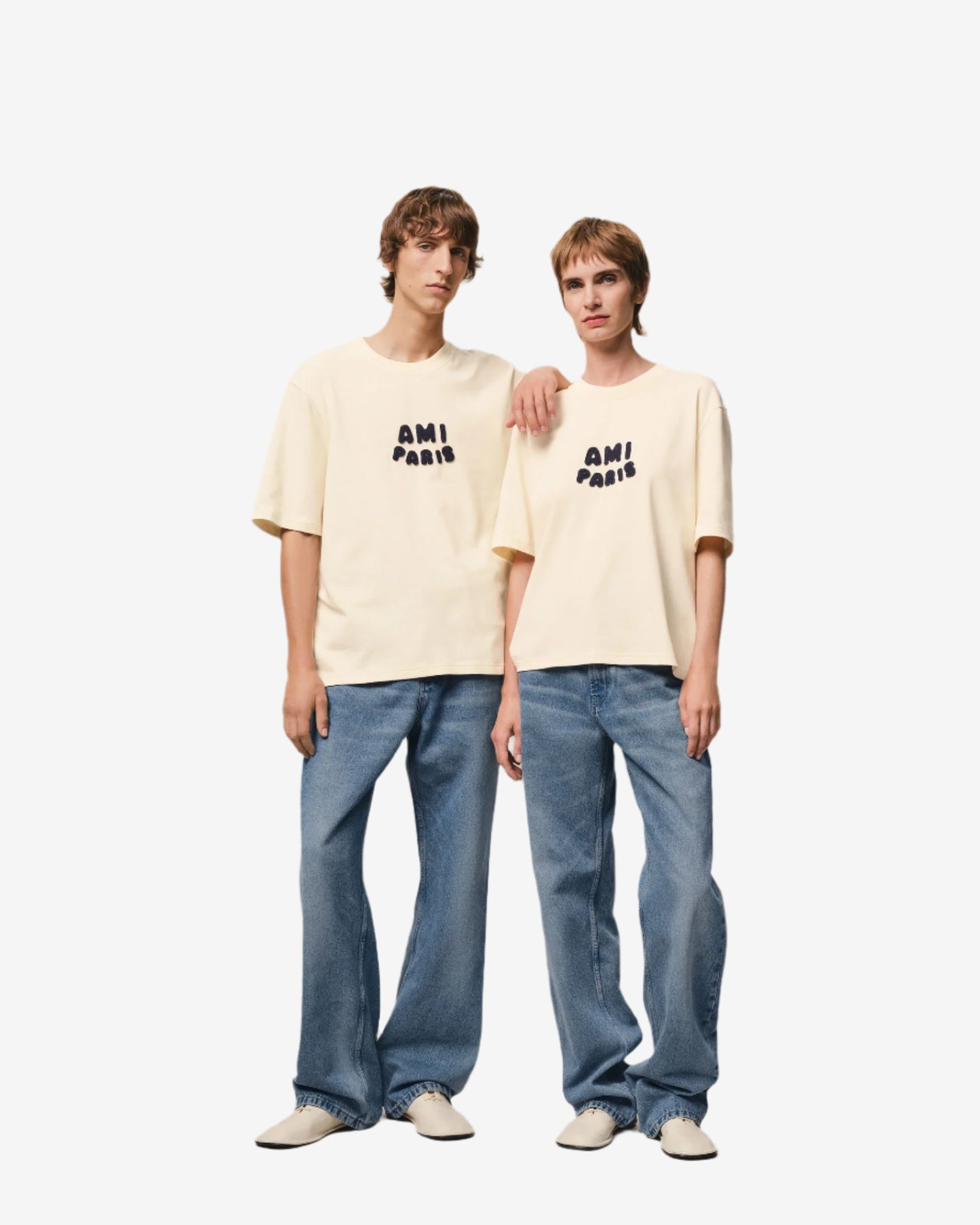 Beige t-shirt with 'AM! PARIS' text on a light gray background
