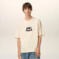 Beige t-shirt with 'AM! PARIS' text on a light gray background