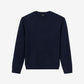 Person wearing a navy blue sweatshirt and blue jeans on a plain background