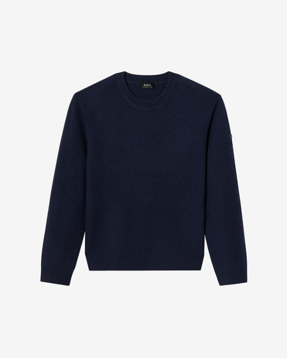 Person wearing a navy blue sweatshirt and blue jeans on a plain background