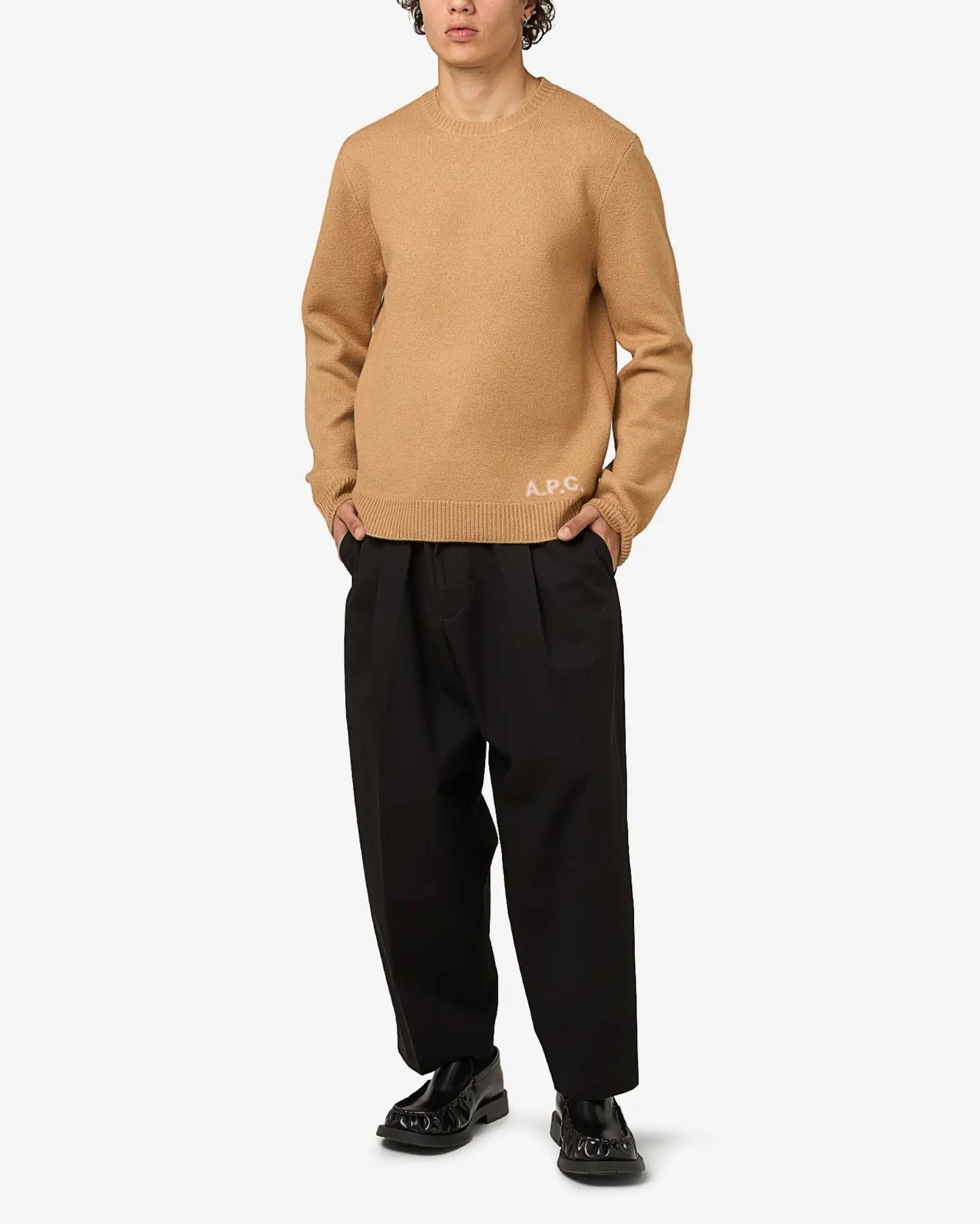 Beige sweater with 'A.P.C.' branding on a light gray background