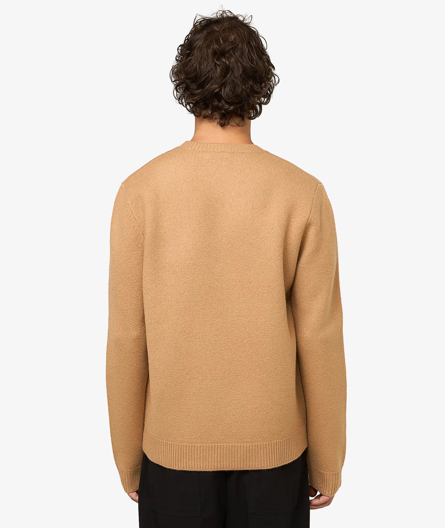 Beige sweater with 'A.P.C.' branding on a light gray background