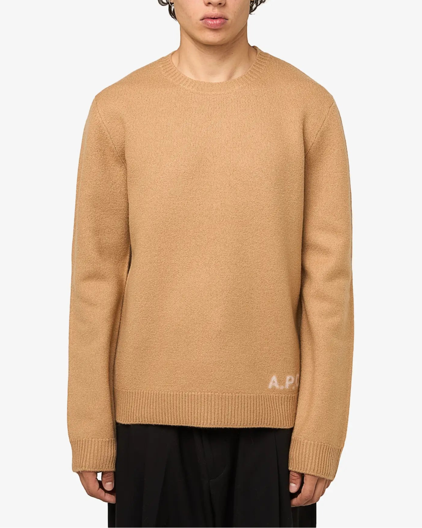 Beige sweater with 'A.P.C.' branding on a light gray background