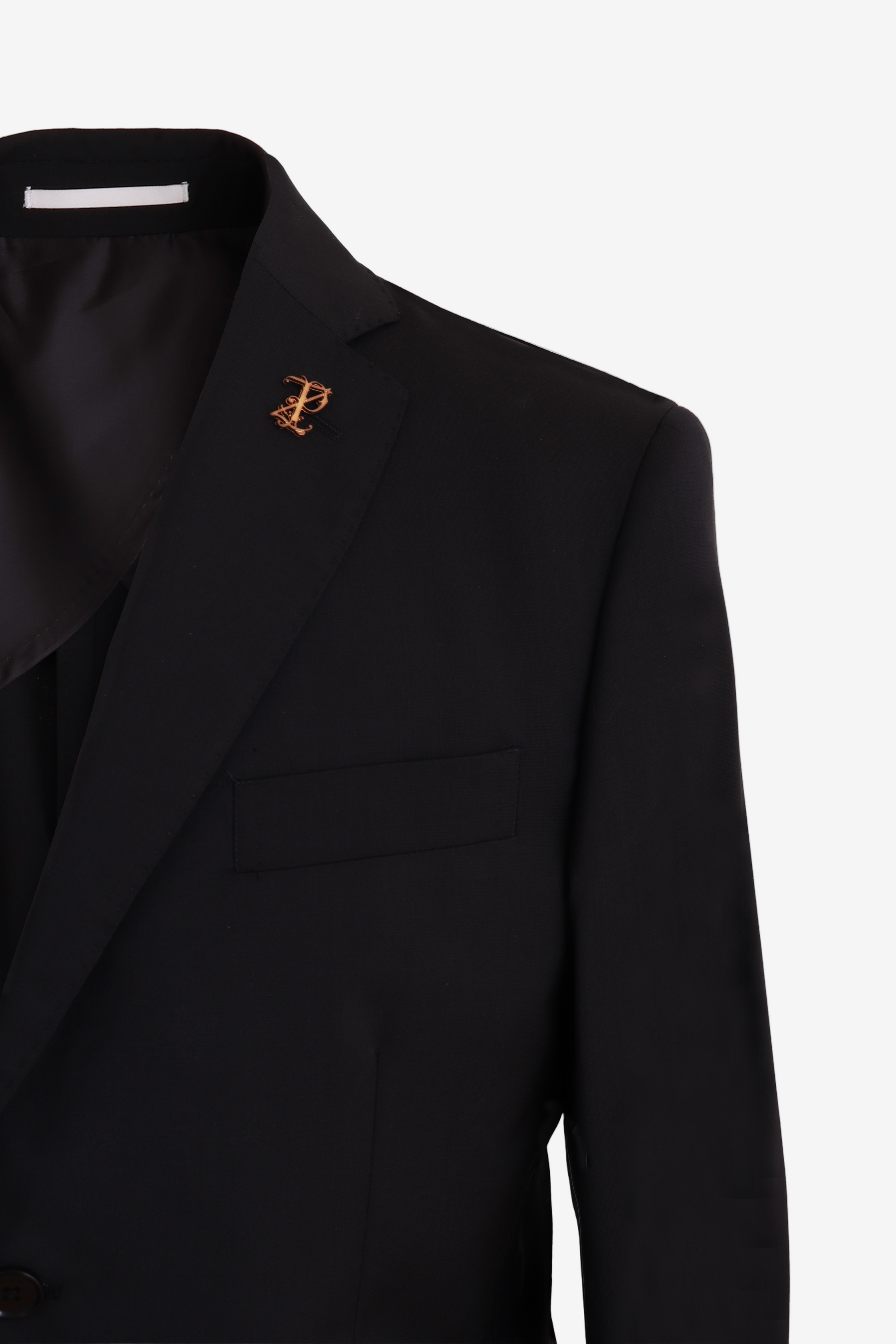Black suit jacket with a gold brooch on a light gray background