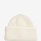 Beige knit sweater with 'Jacquemus' branding on a light background