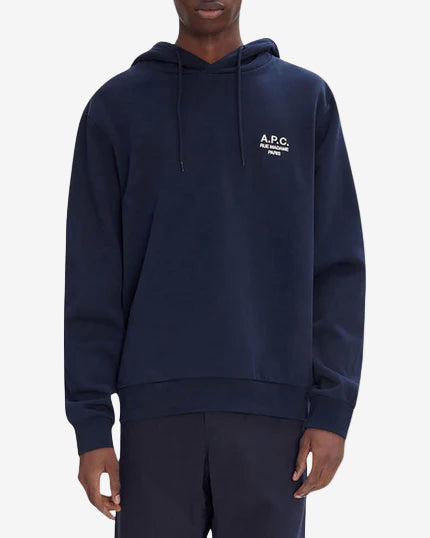 Navy hoodie with A.P.C. logo worn by a person on a white background