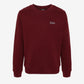 Maroon sweatshirt with a small logo on a white background