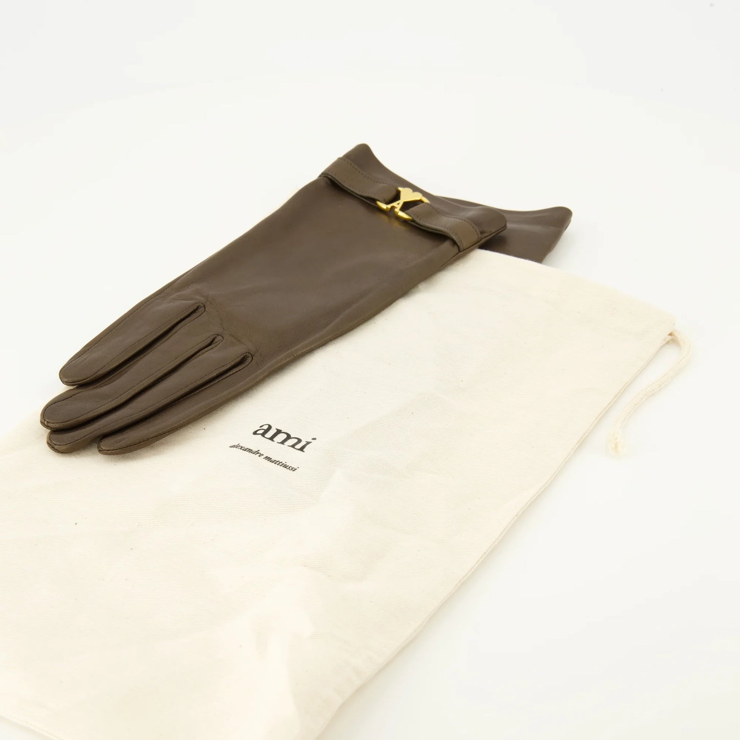 Pair of brown gloves with gold logo on a white background AMI PARIS