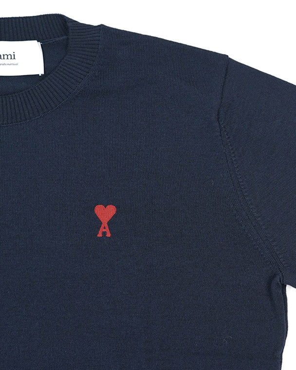 Navy blue sweater with a red heart and letter 'A' logo on a white background