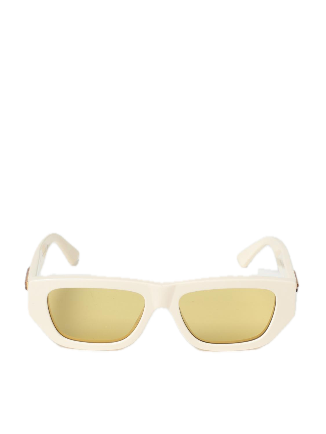 White sunglasses with gold lenses on a white background
