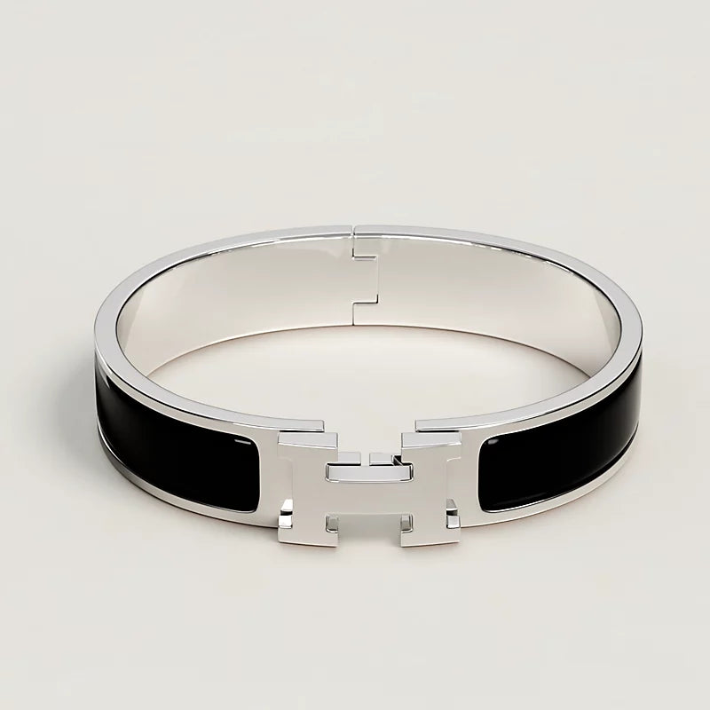 Silver bracelet with black accents on a light gray background