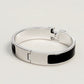 Silver bracelet with black accents on a light gray background