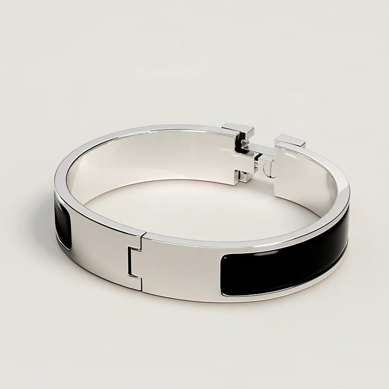 Silver bracelet with black accents on a light gray background