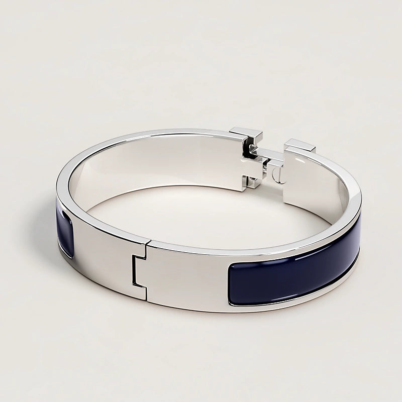 Silver bracelet with blue accents on a light gray background