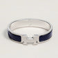 Silver bracelet with blue accents on a light gray background