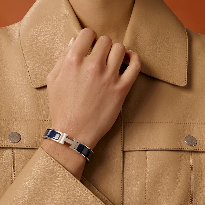 Silver bracelet with blue accents on a light gray background
