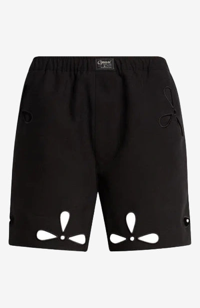 Black shorts with cut-out designs on a white background