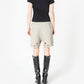 Beige shorts with cut-out designs on a white background