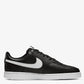 Black sneaker with white swoosh logo on a white background