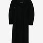 Black coat with 'Jil Sander' label on a white background