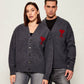 Dark gray cardigan with a red heart emblem on a beige background ami paris