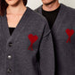 Dark gray cardigan with a red heart emblem on a beige background ami paris