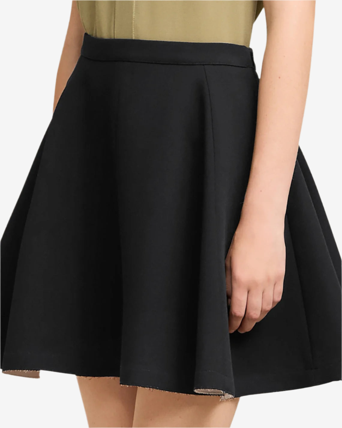 Black skirt worn by a person on a neutral background