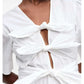 White Dress with decorative ties Ganni