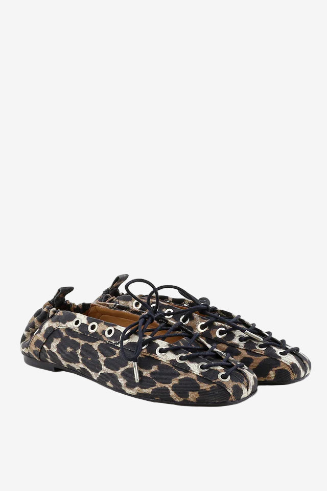 Leopard print shoes with black laces on a white background